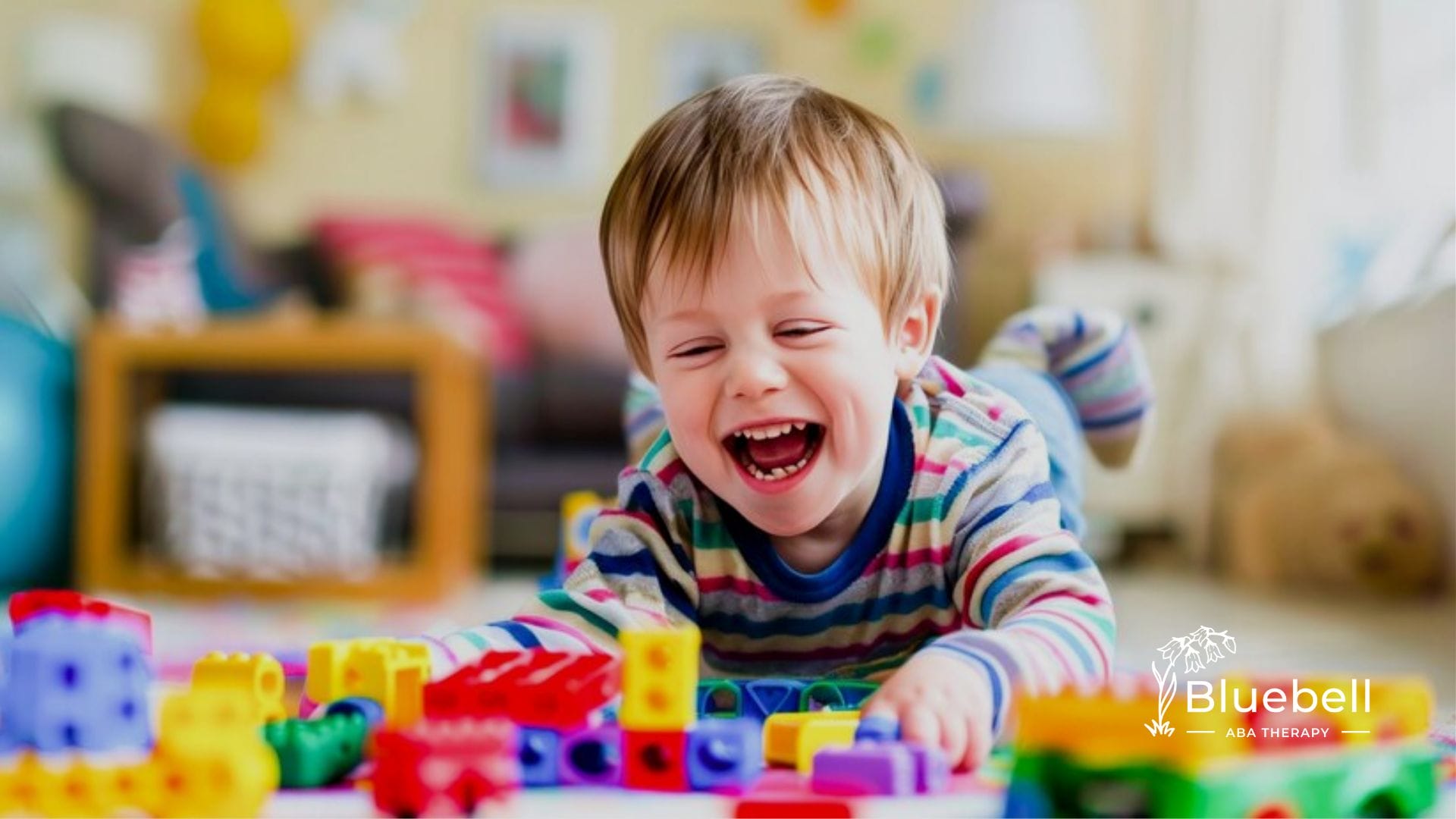 A child happily playing with colorful blocks