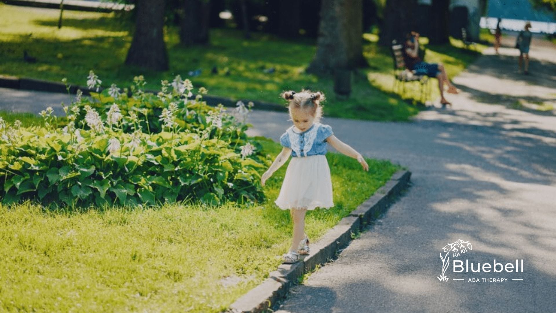 A little girl walking outside.