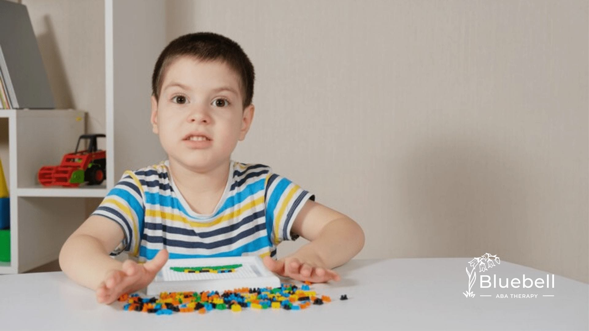 A child playing with mini Legos on a table
