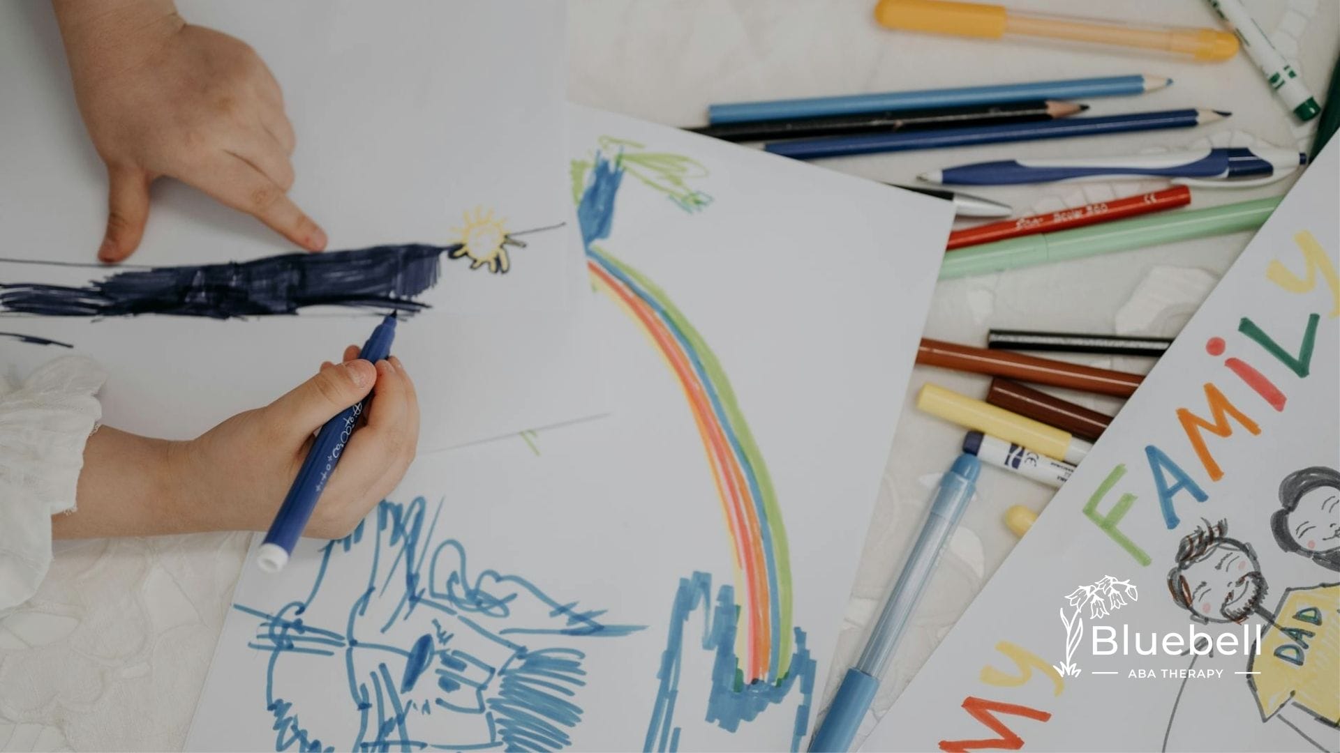 An autistic child drawing on paper with markers during sensory processing disorder test in NC.