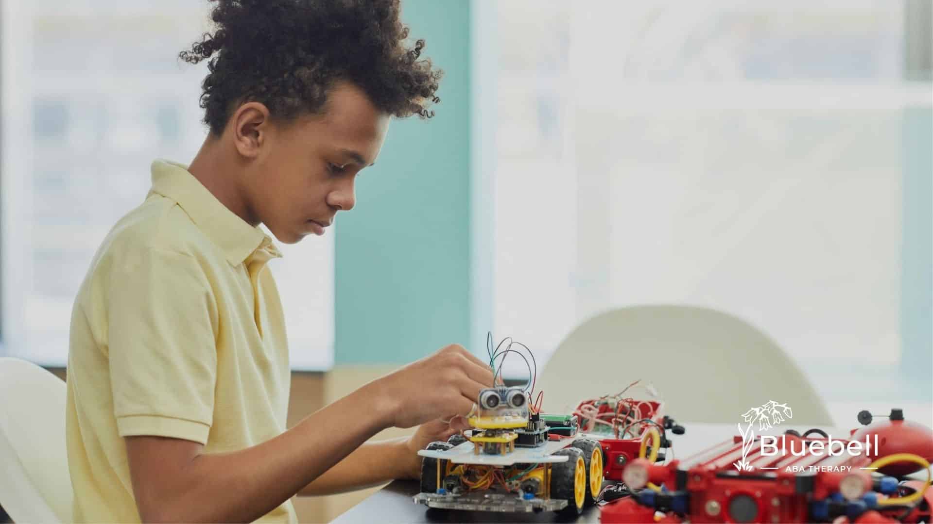 An autistic child building a robot during an ABA therapy session at his home in North Carolina.