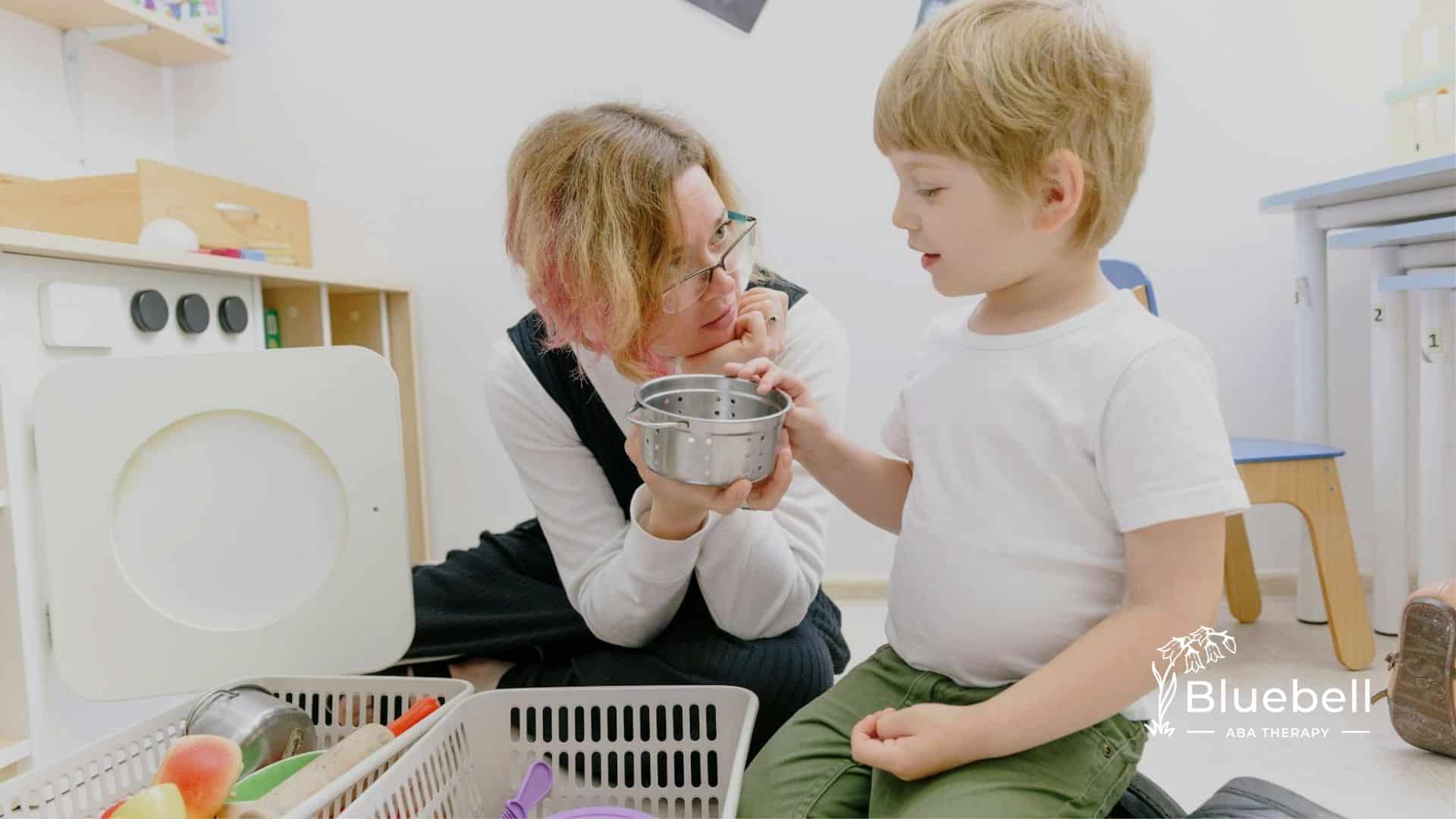 A BCaBA interacting with an autistic boy in a play-based learning environment in North Carolina.