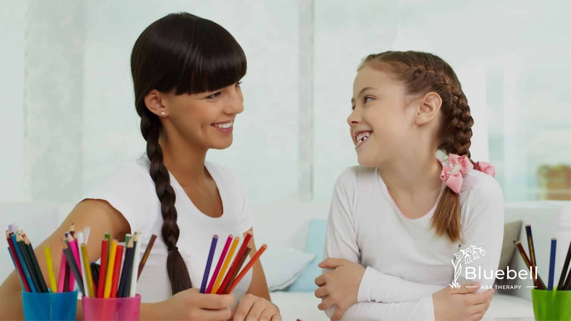A BCBA and child engaged in a drawing activity.