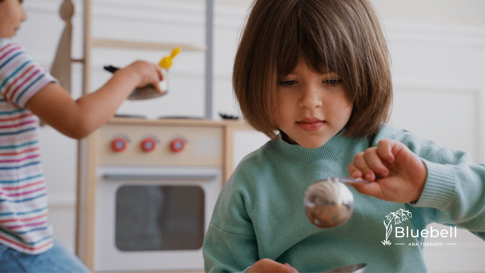 Two children with autism playing with sensory toys during ABA therapy