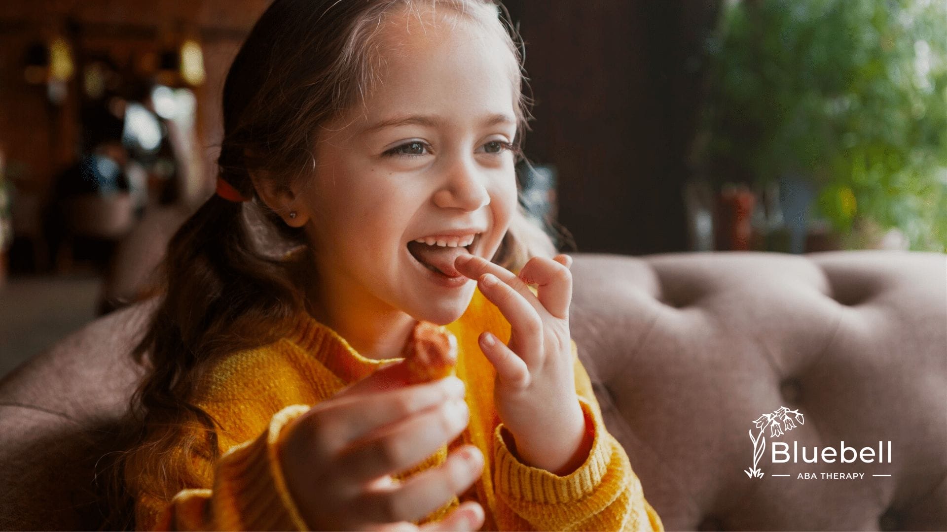 A child with autism licking her fingers