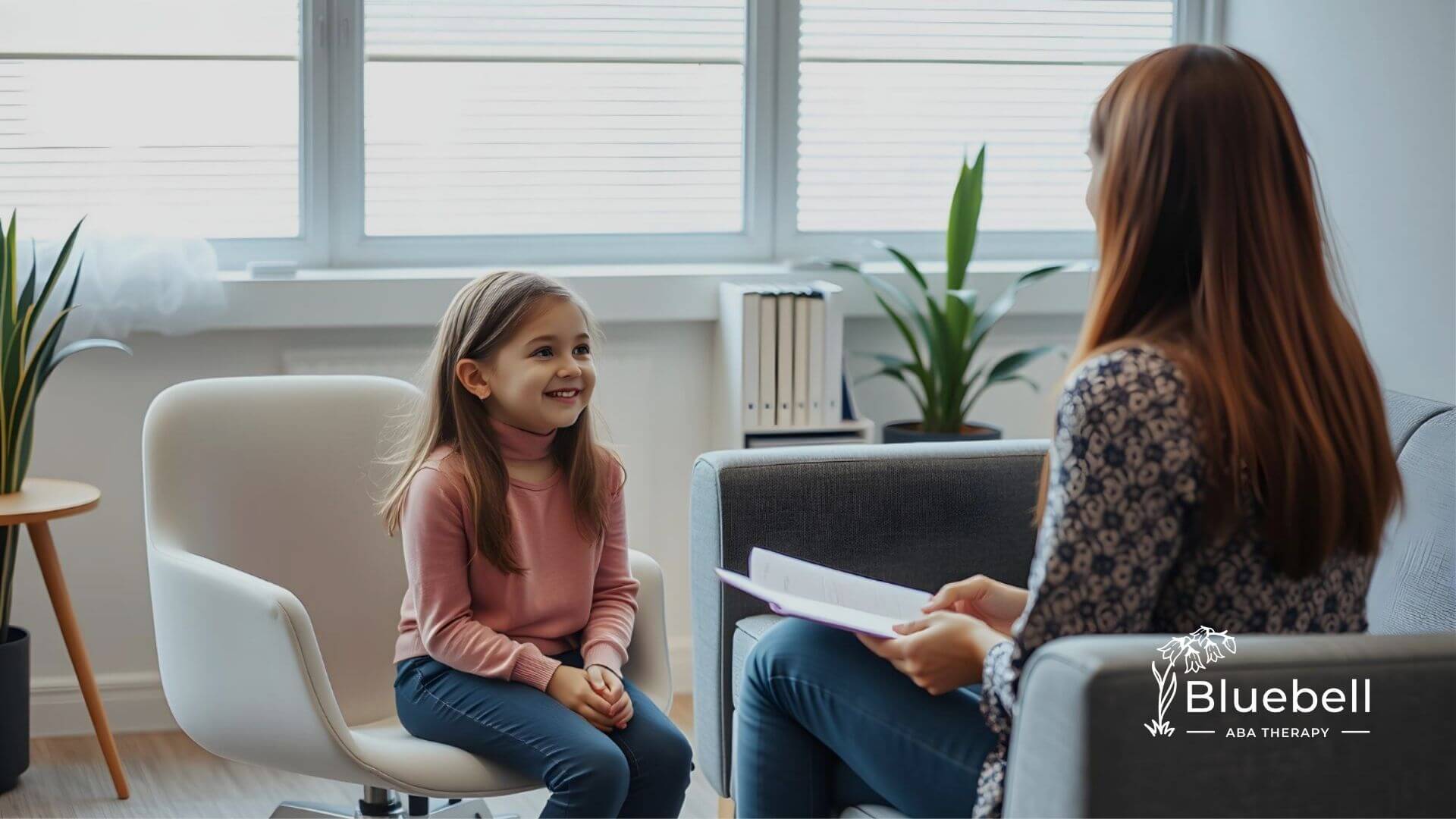 A child with autism smiles during an ABA therapy session with a BCBA.